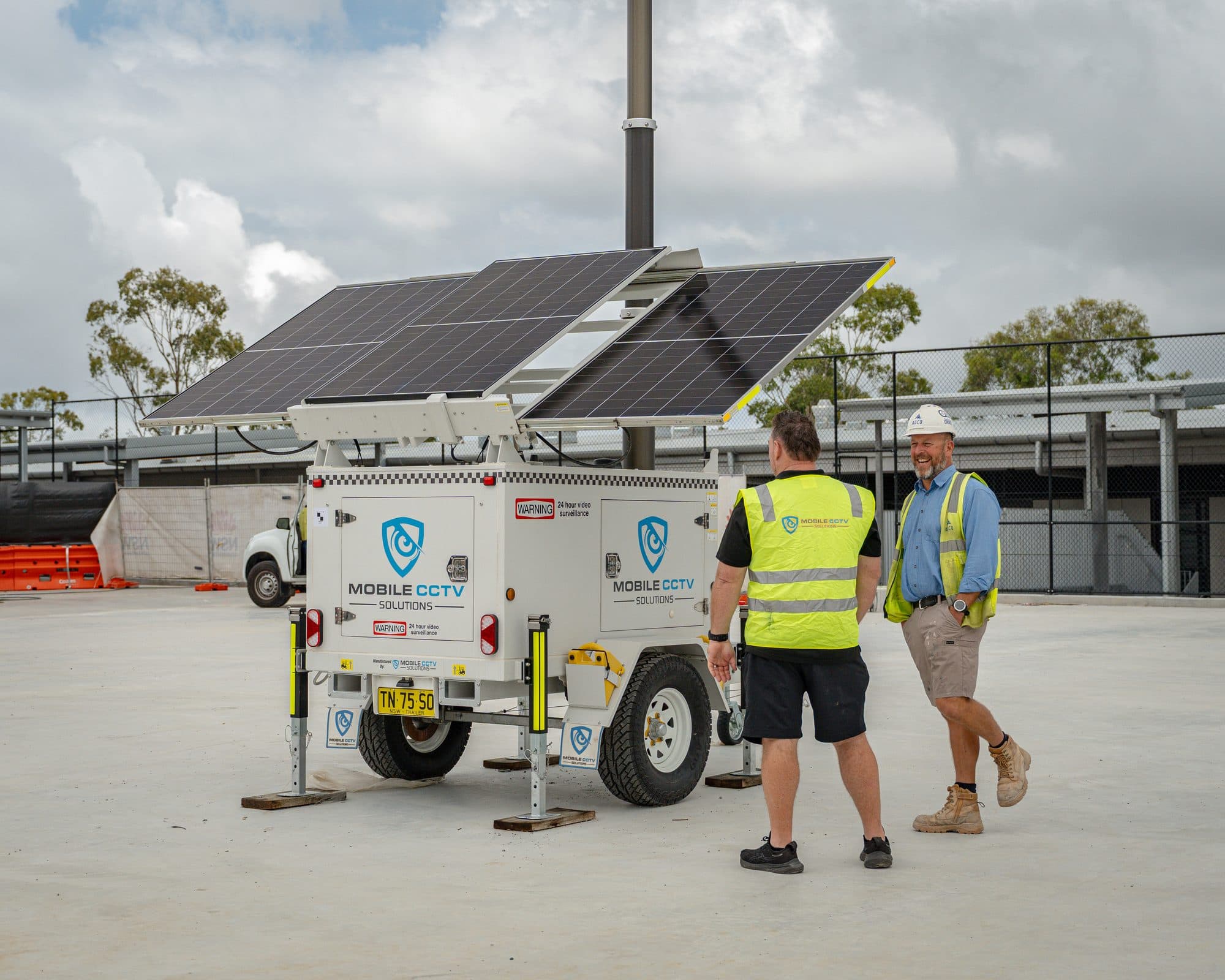 Mobile CCTV Solutions team with ADCO Constructions staff beside a trailer at The Forest High School site