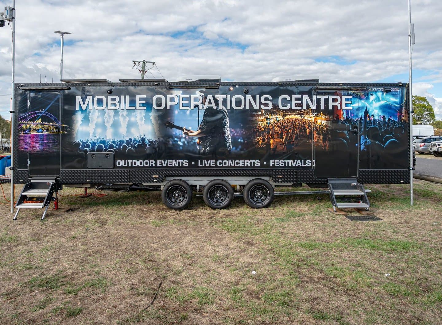 Mobile CCTV Solutions' Mobile Operations Centre trailer branded for outdoor events, live concerts and festivals