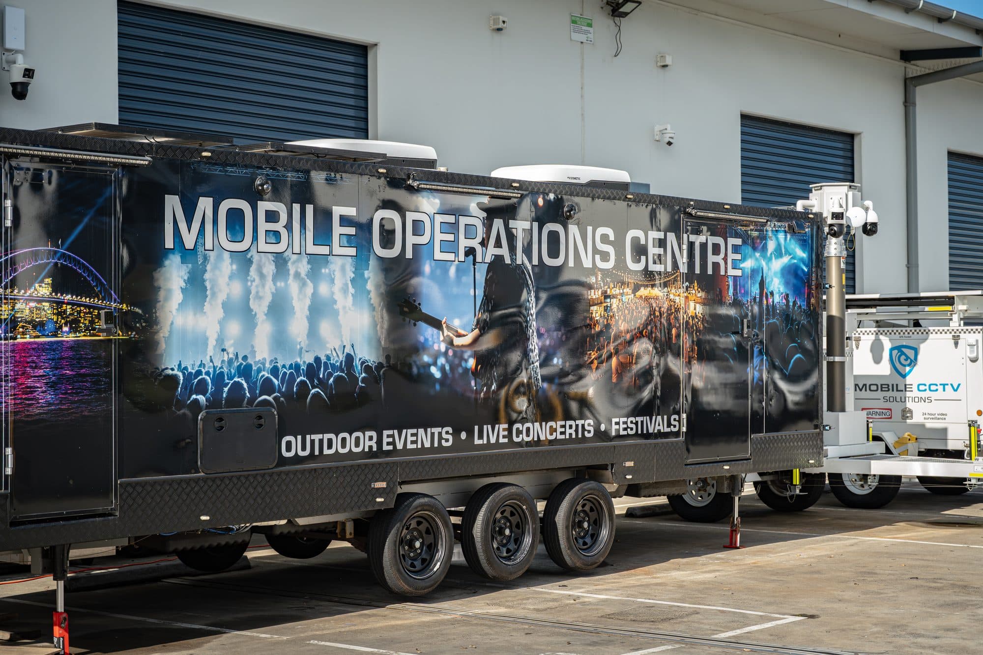 Mobile Operations Centre trailer, branded for outdoor events, live concerts and festivals, with a Mobile CCTV Solutions camera tower alongside