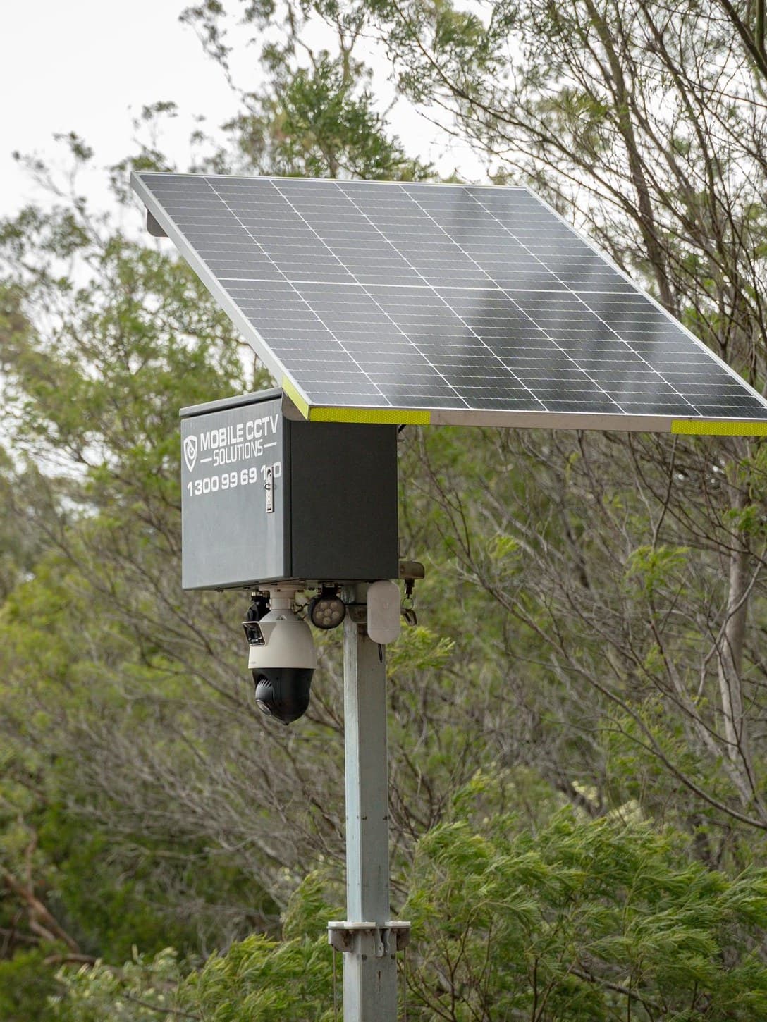 A Mobi Pole Cam solar-powered surveillance unit on a pole against bushland