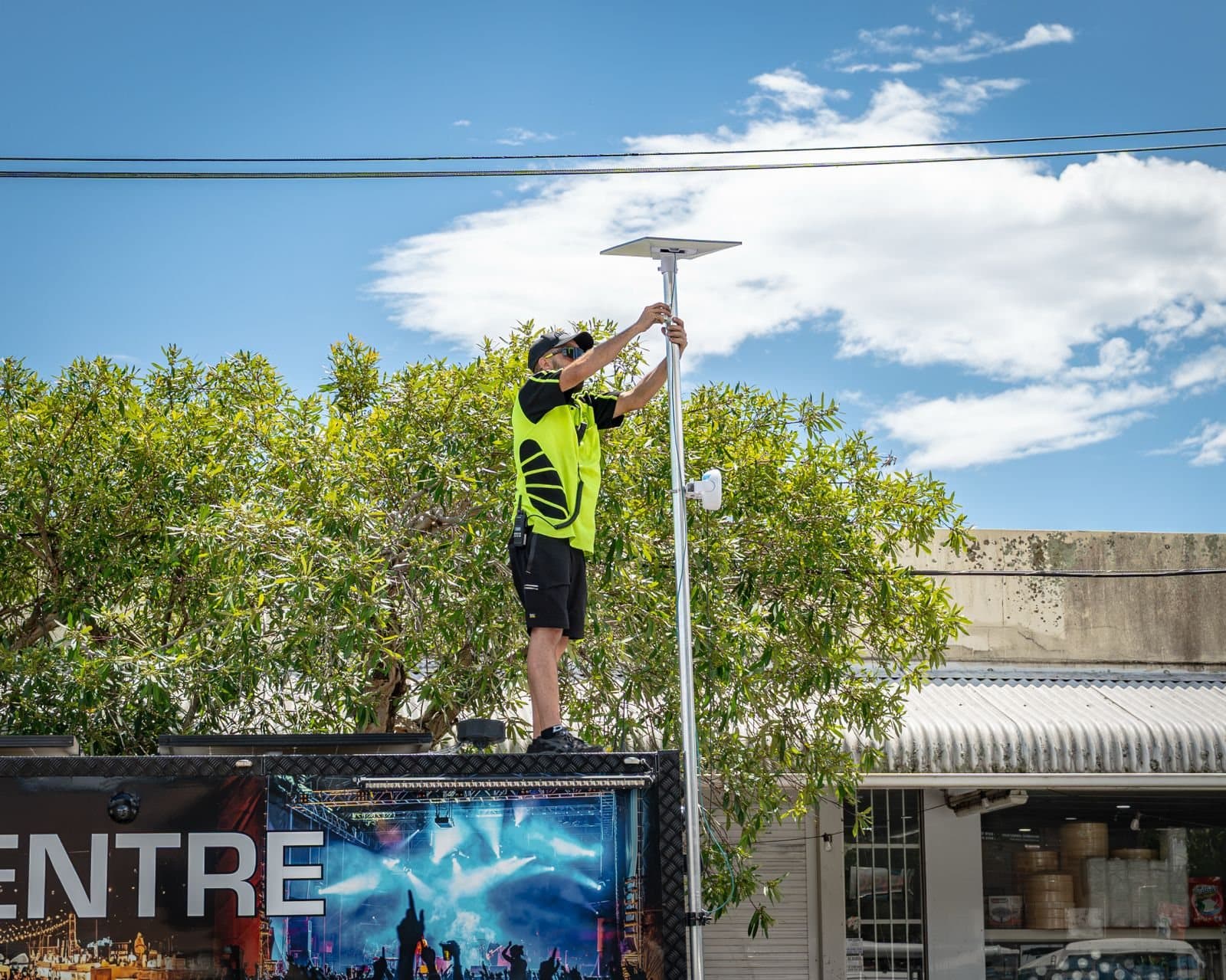 A technician fitting a pole-mounted unit on site