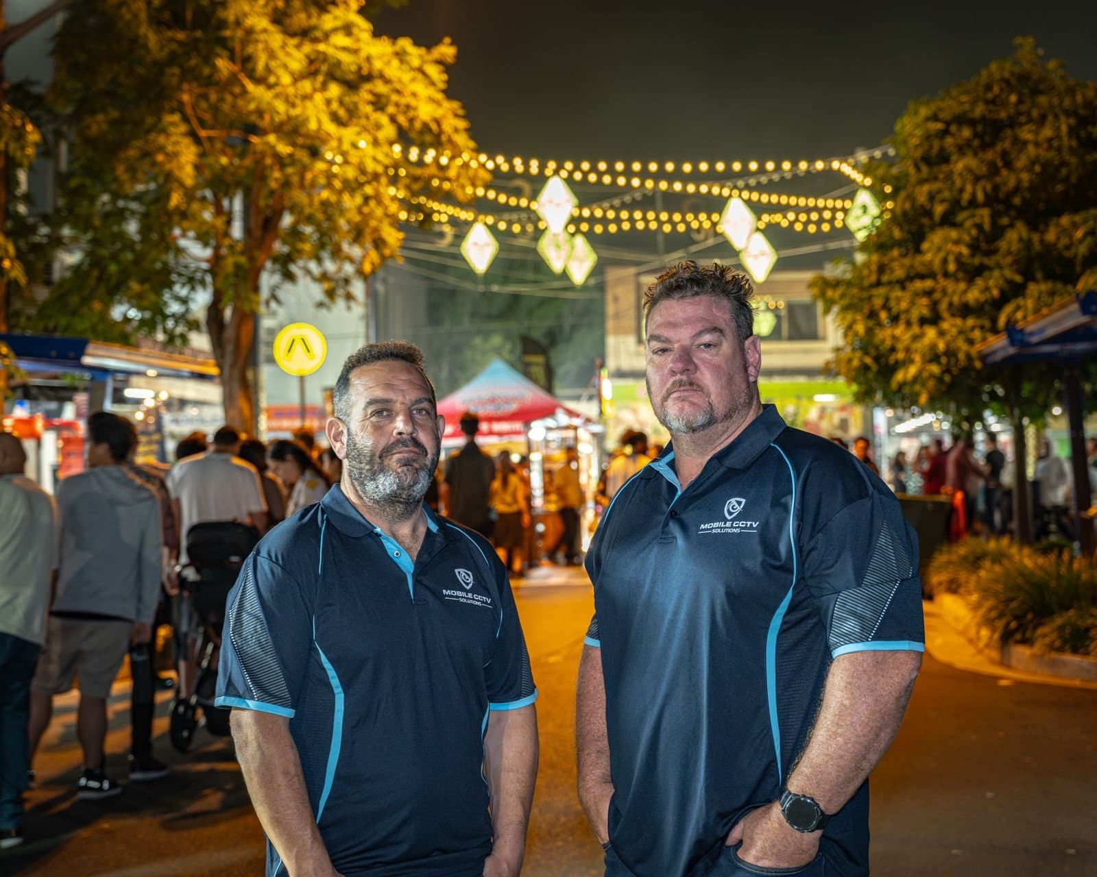 Two Mobile CCTV Solutions team members at a night event