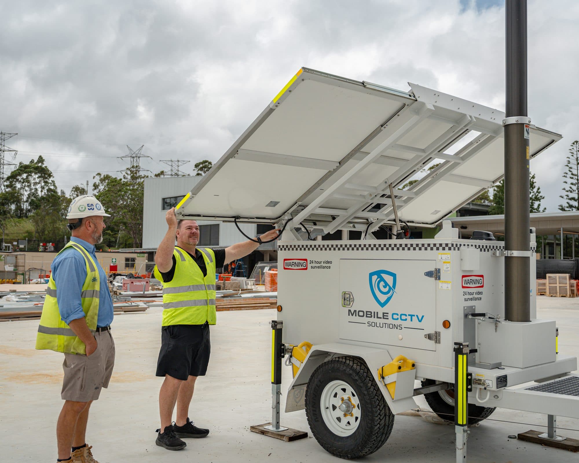 Mobile CCTV Solutions team inspecting a deployed trailer's solar panel on a construction site